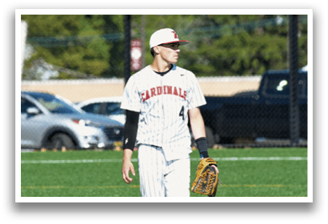 A baseball player wearing a white and black uniform. Description generated by AI
