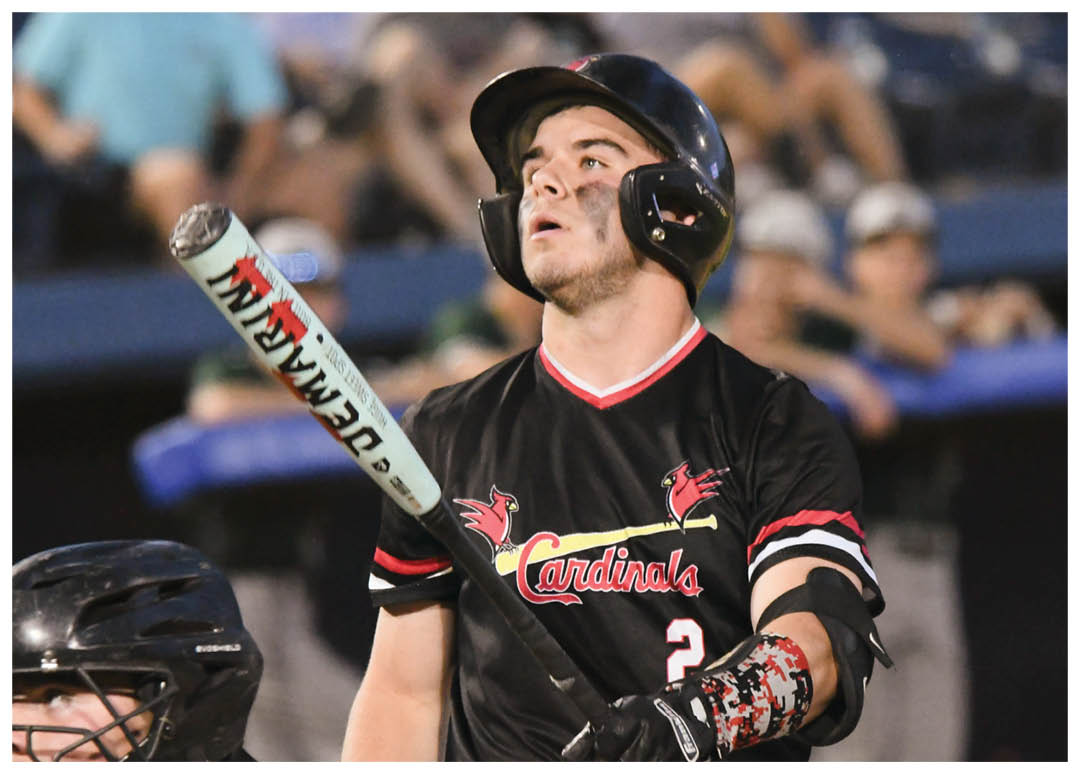 A baseball player holding a bat. Description generated by AI