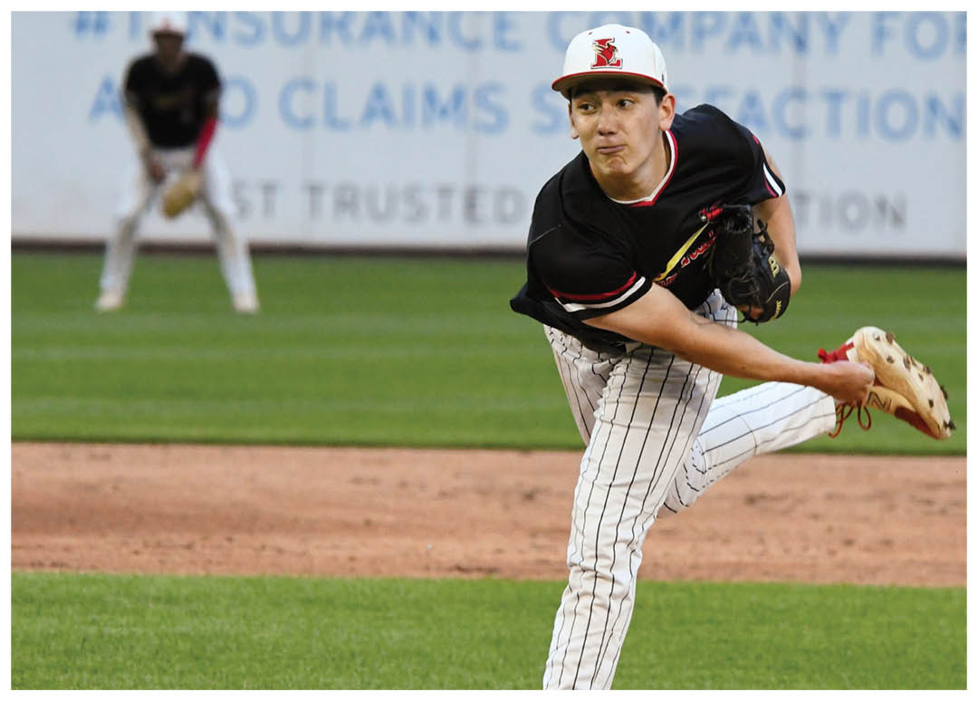 A baseball player in a red helmet and white uniform is holding a bat and getting ready to swing. Description generated by AI