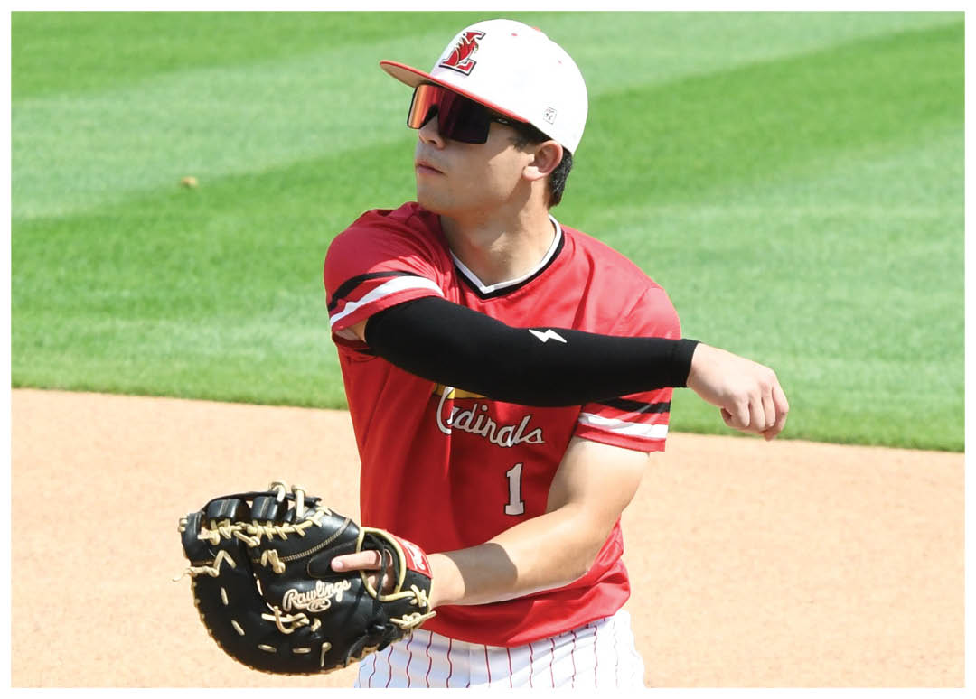 A baseball player in a red and white uniform is holding a baseball glove. Description generated by AI