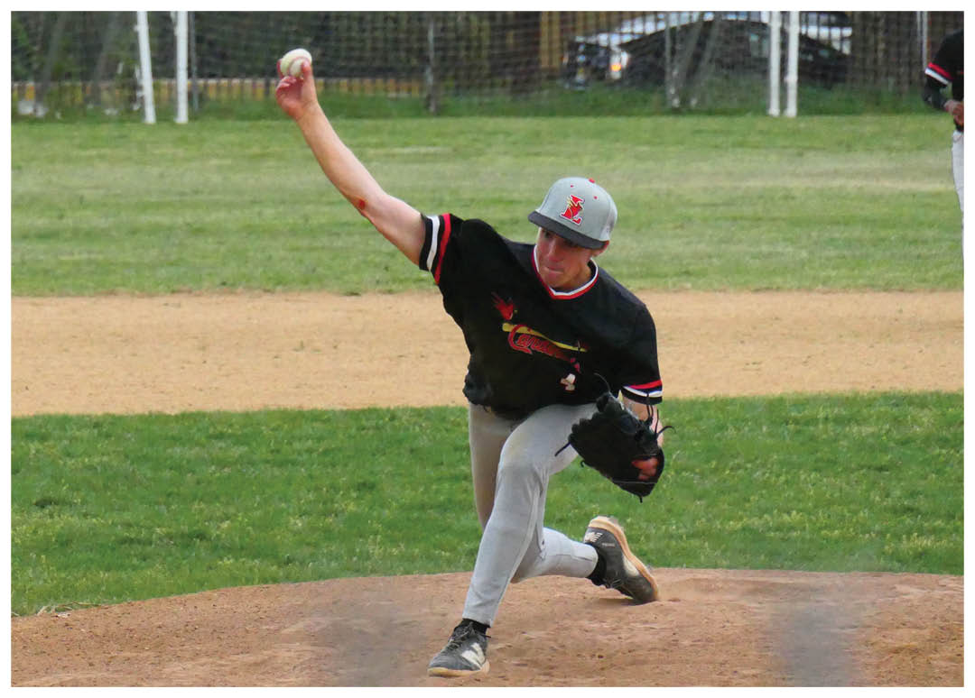 A baseball player in a black shirt and grey pants is throwing a baseball. Description generated by AI