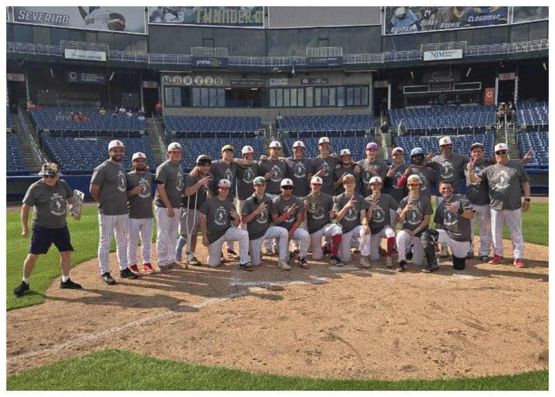 A group of baseball players posing for a picture on the field. Description generated by AI