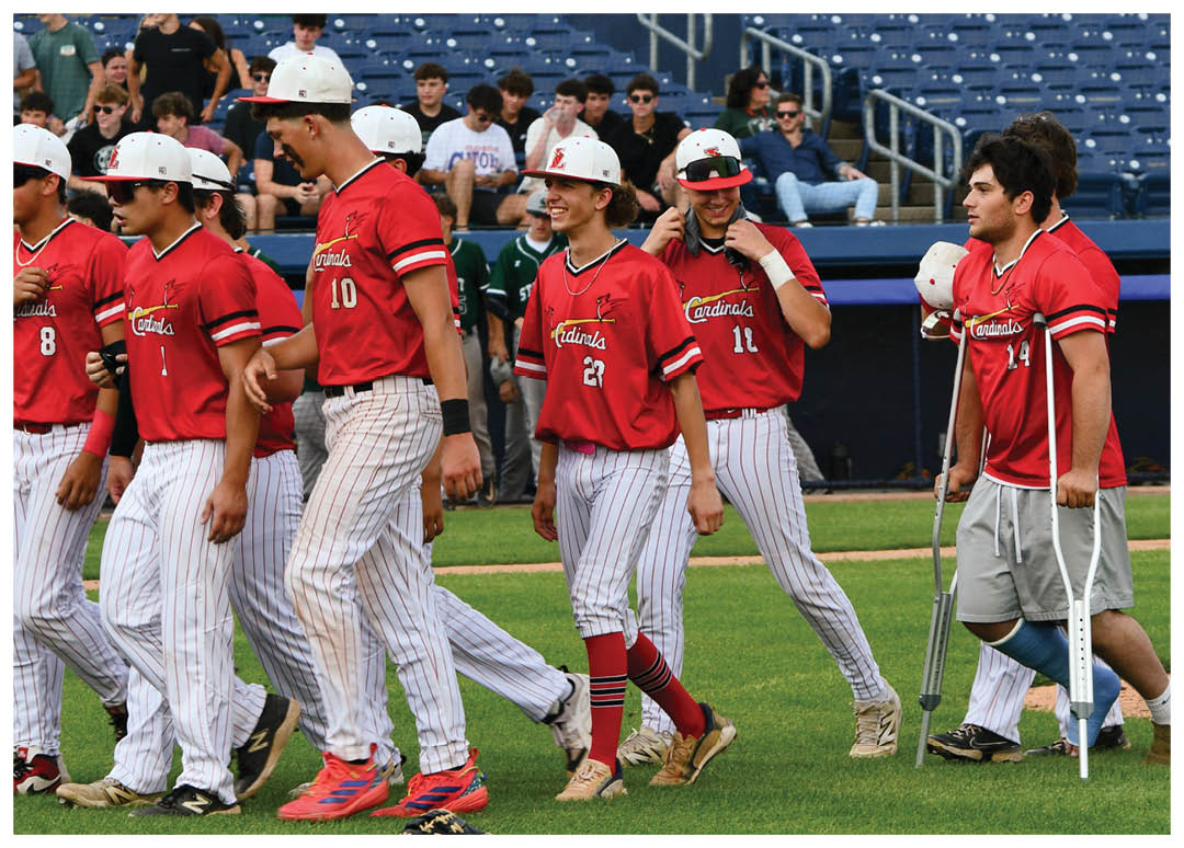 A group of baseball players walking on the field. Description generated by AI