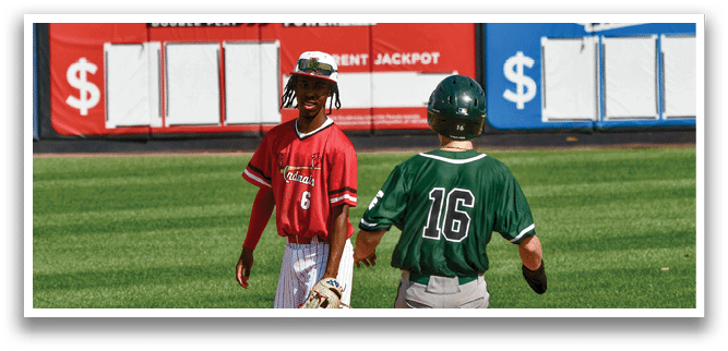 A baseball player in a red shirt and white pants is standing on a base. Description generated by AI