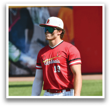 A baseball player wearing a red and white jersey. Description generated by AI