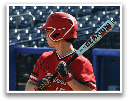 A baseball player holding a bat. Description generated by AI