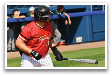 A baseball player wearing a red shirt and black gloves. Description generated by AI