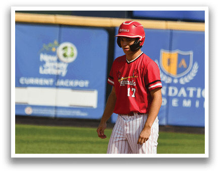 A baseball player wearing a red shirt and white pants. Description generated by AI
