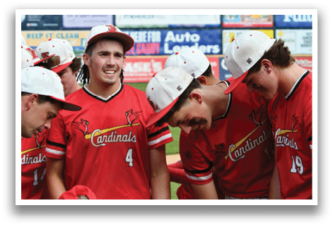 A group of baseball players wearing red jerseys. Description generated by AI