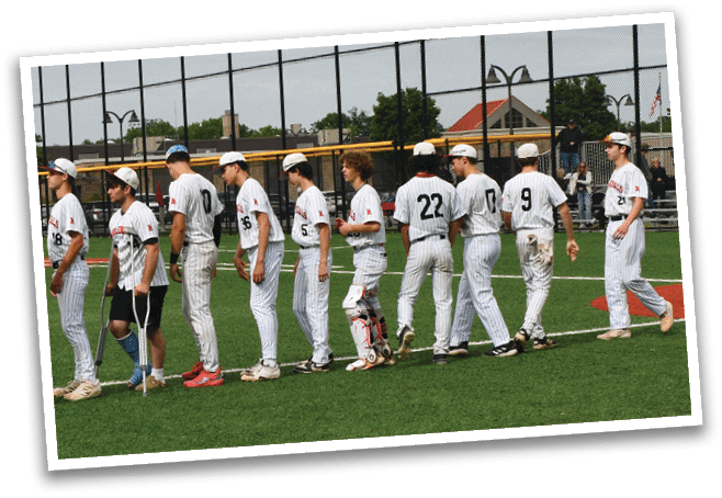 Baseball players wearing white uniforms and red shoes. Description generated by AI
