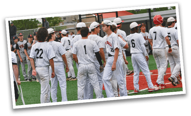 Baseball players standing on a field. Description generated by AI