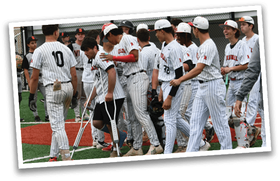 A group of baseball players walking on a field. Description generated by AI