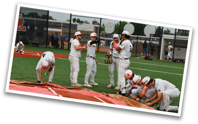 A group of baseball players are gathered on a field. Description generated by AI
