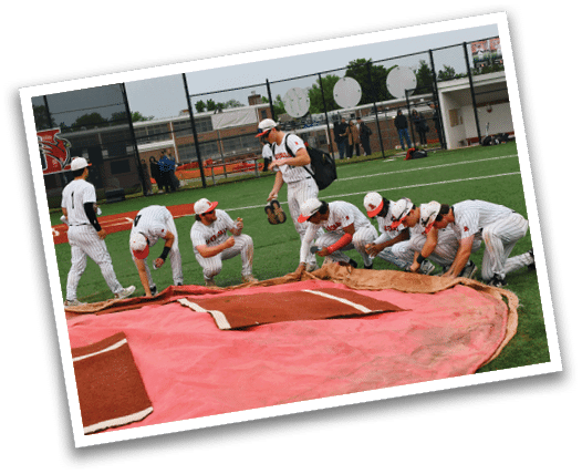 A group of baseball players are kneeling on a baseball field. Description generated by AI