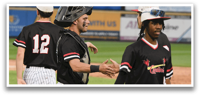 A baseball player wearing a black shirt and hat shakes hands with another player. Description generated by AI