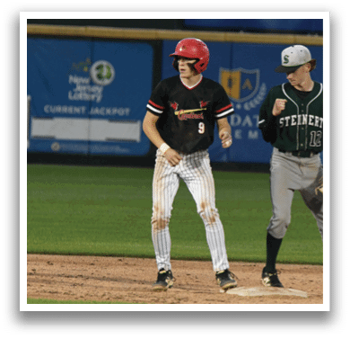 Two baseball players on a field. Description generated by AI