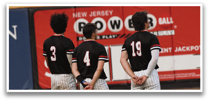 Three baseball players standing on a field. Description generated by AI