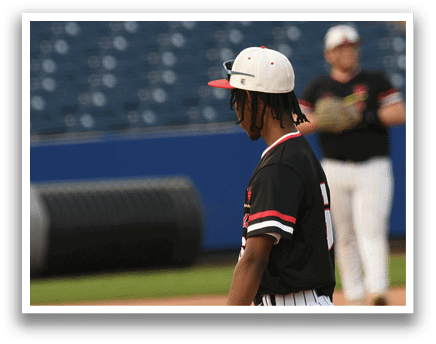 A baseball player wearing a black and red jersey. Description generated by AI