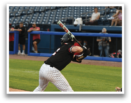 A baseball player is swinging a bat at a ball. Description generated by AI