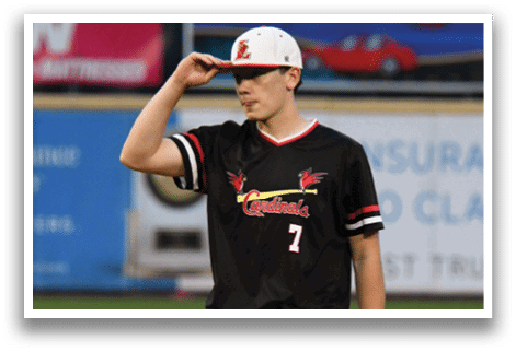 A baseball player wearing a black and red jersey with the number 7 on it. Description generated by AI