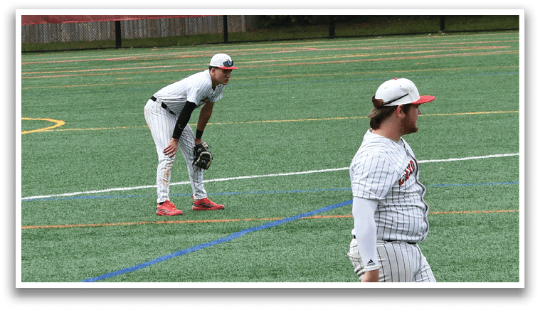 A baseball field with three players standing on it. Description generated by AI
