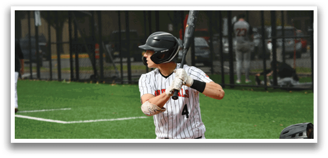 A baseball player in a black helmet and white uniform is holding a bat and preparing to swing. Description generated by AI