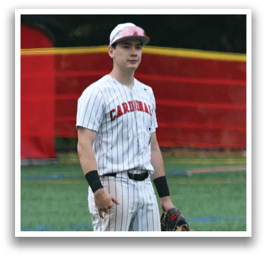 A baseball player wearing a pink hat and white uniform. Description generated by AI