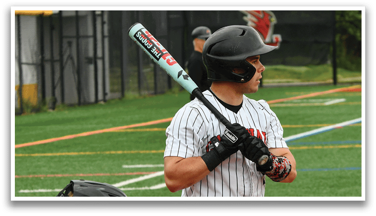 A baseball player holding a bat. Description generated by AI