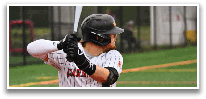 A baseball player in a black and white striped uniform is swinging a bat. Description generated by AI