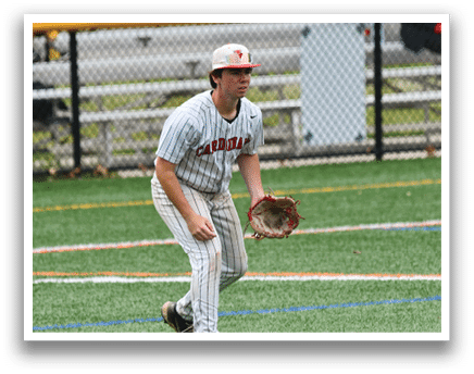 A baseball player in a grey and red uniform is standing on a baseball field. Description generated by AI