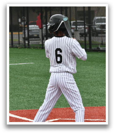 A baseball player wearing a black helmet and a white jersey with the number 6 on it. Description generated by AI