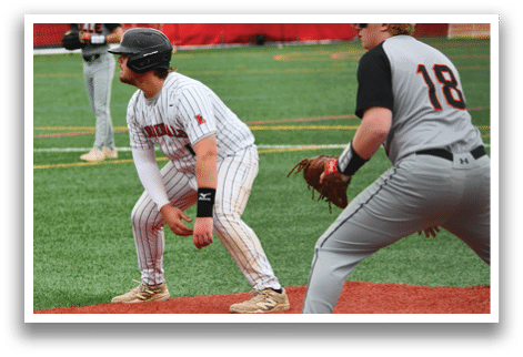 A baseball player wearing a black helmet and white and black uniform. Description generated by AI