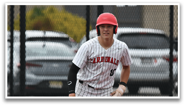 A baseball player wearing a red helmet and white and black uniform. Description generated by AI