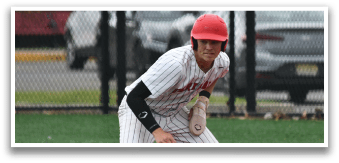 A baseball player wearing a red helmet and white uniform is running on the field. Description generated by AI