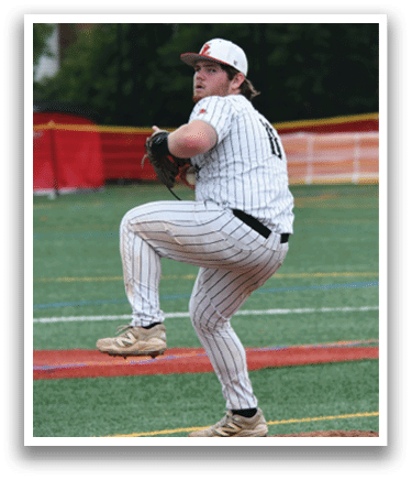A baseball player in a white and black uniform is pitching a ball. Description generated by AI