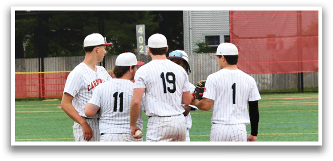 A group of baseball players standing on a field. Description generated by AI