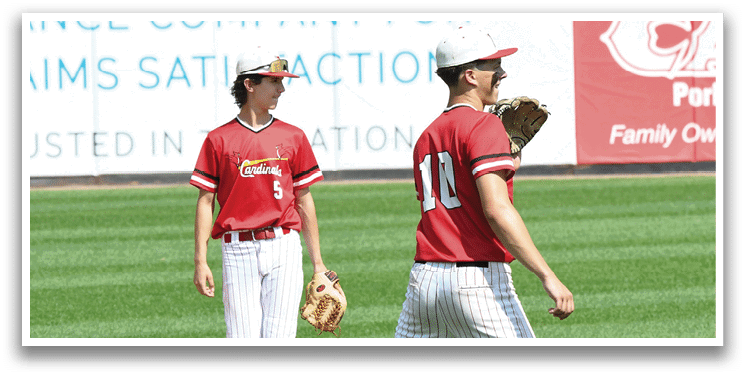 Two baseball players walking on a field. Description generated by AI