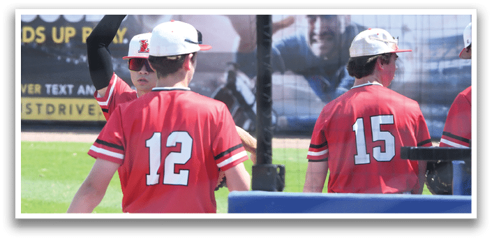 A baseball player wearing a red jersey with the number 12 on it. Description generated by AI