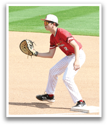 A baseball player wearing a red shirt and white pants is catching a ball. Description generated by AI