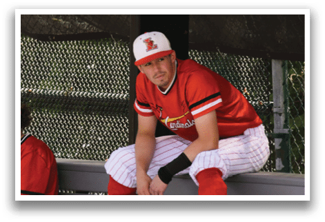 Two baseball players sitting on a bench. Description generated by AI