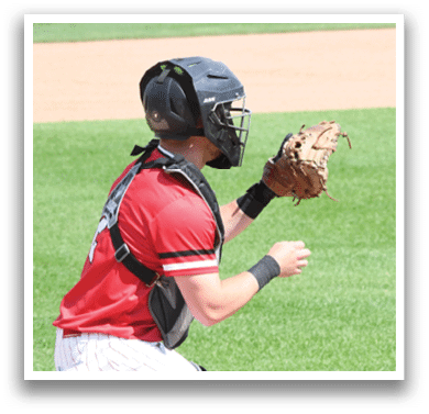 A baseball player wearing a red shirt and black helmet. Description generated by AI