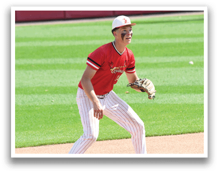 A baseball player wearing a red shirt and white pants. Description generated by AI