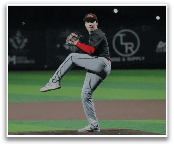 A baseball player in a black and red uniform is pitching a ball on a field. AI generated content