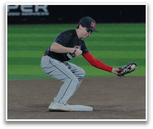 A baseball player in a black shirt and red socks is catching a ball. AI generated content