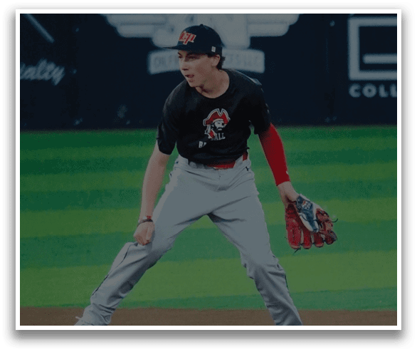 A baseball player in a black and red shirt and grey pants is standing on a baseball field. AI generated content