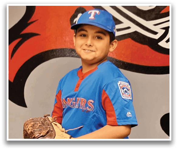 A young boy wearing a blue baseball uniform and a blue hat is holding a baseball glove. AI generated content