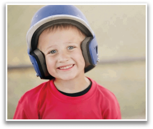 A young boy wearing a baseball helmet and a red shirt. AI generated content