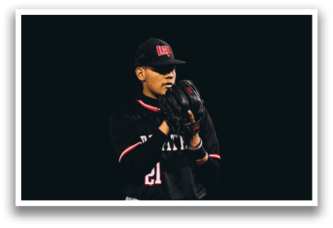 A baseball player in a black shirt and hat is standing on a field. AI generated content