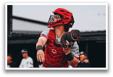 A baseball player in a red helmet and grey uniform is throwing a ball. AI generated content