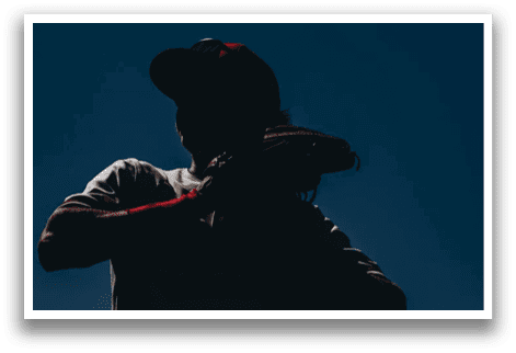 A person wearing a baseball glove and a hat is standing in front of a blue sky. AI generated content